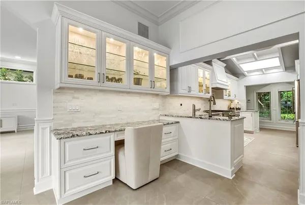 a kitchen with granite countertop white cabinets and white appliances