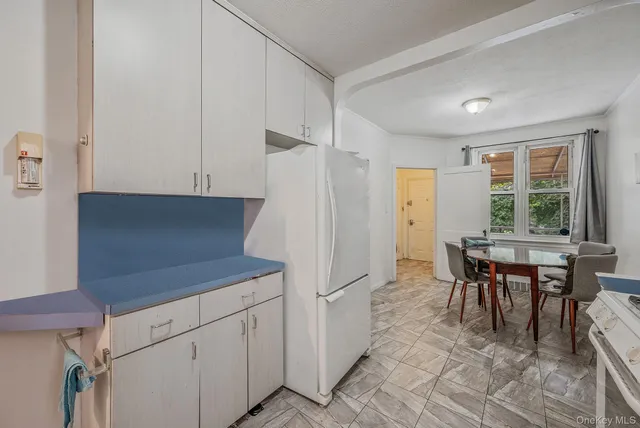 a kitchen with cabinets appliances a sink and a window