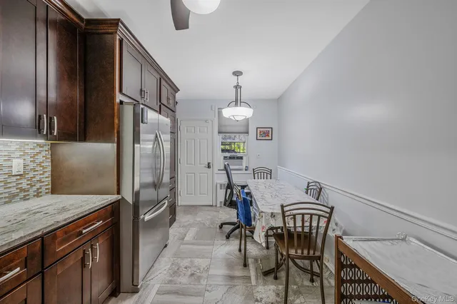 a kitchen with stainless steel appliances granite countertop wooden cabinets and a stove top oven