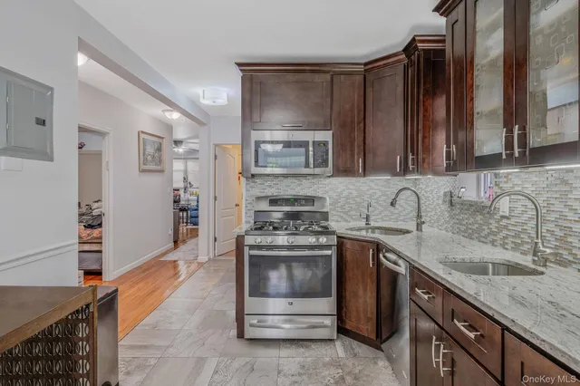 a view of a dining room with furniture and chandelier