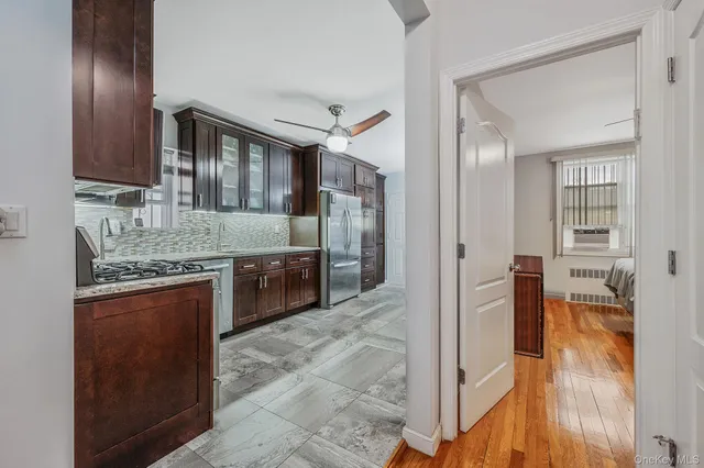 a view of a hallway and wooden floor an entryway and livingroom