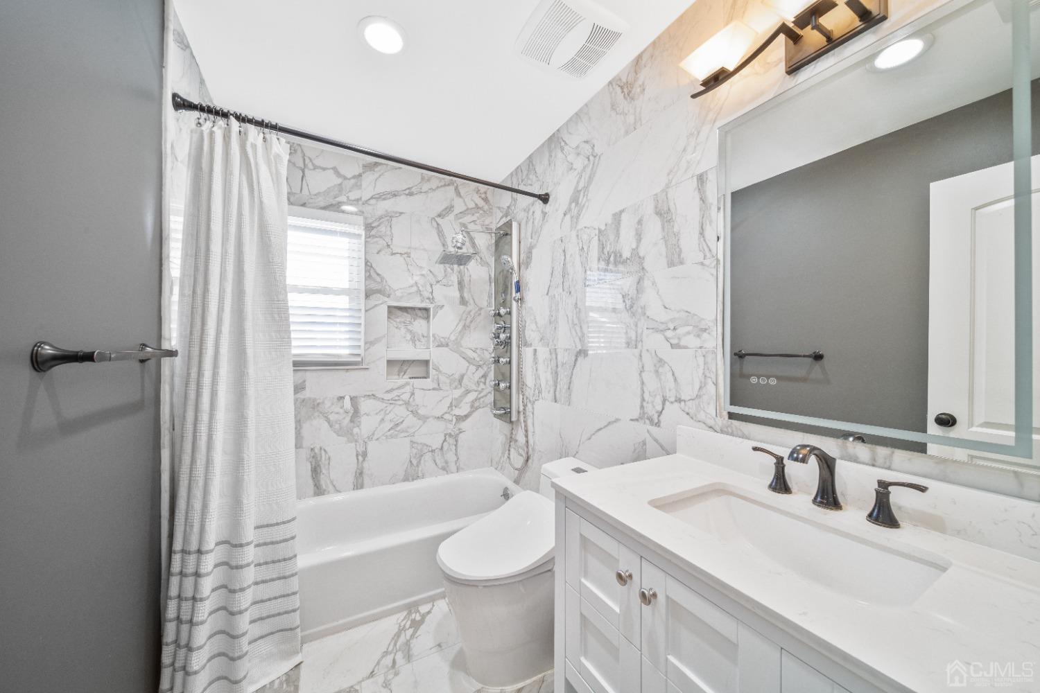 3 South Gate Springfield, NJ 07081 - Photo 14 of 22 a bathroom with a sink a toilet and shower