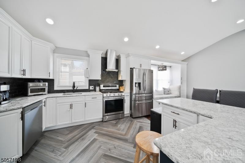 3 South Gate Springfield, NJ 07081 - Photo 2 of 22 a kitchen with white cabinets and stainless steel appliances