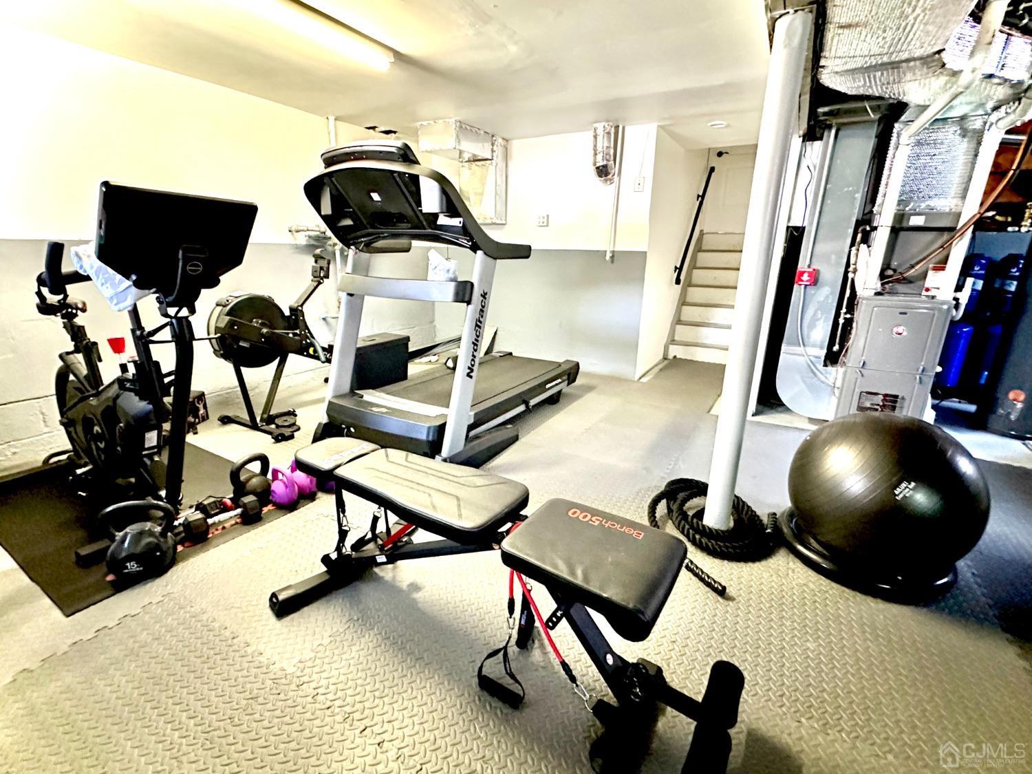 3 South Gate Springfield, NJ 07081 - Photo 22 of 22 a room with gym equipment and wooden floor