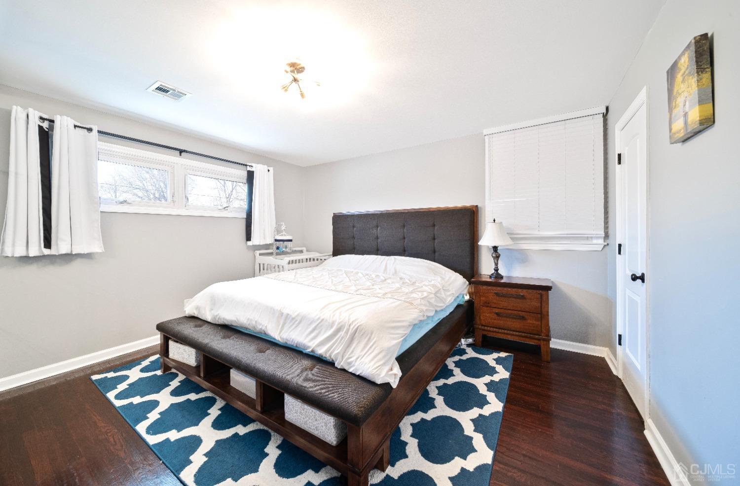 3 South Gate Springfield, NJ 07081 - Photo 10 of 22 a bedroom with a bed and wooden floor