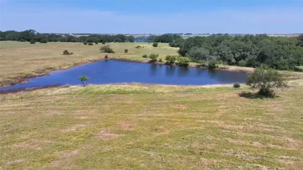 a view of a lake with houses in the back