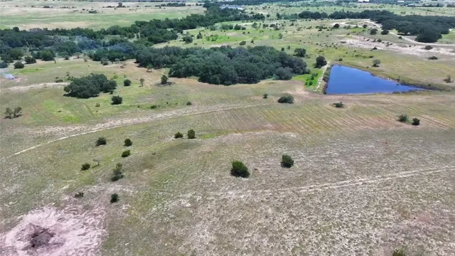 a view of a field with trees in the background
