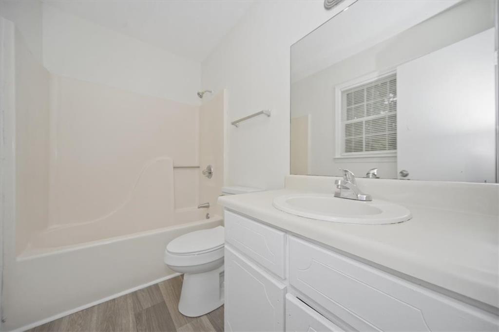 1496 Cherry Hill Road Southwest Conyers, GA 30094 - Photo 17 of 32 a bathroom with a sink a toilet and shower