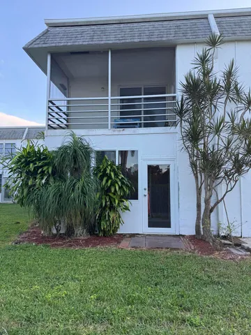 a couple of potted plants in front of house