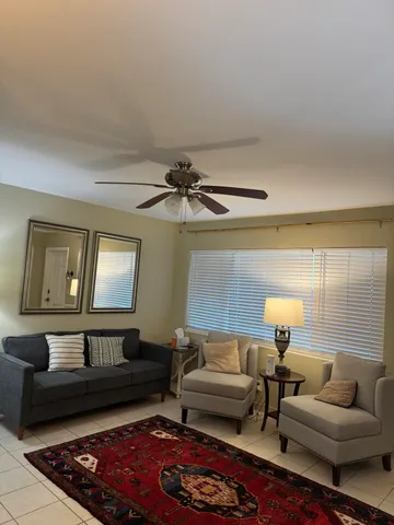 a living room with furniture and a rug
