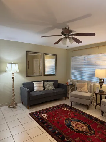 a living room with furniture and a lamp