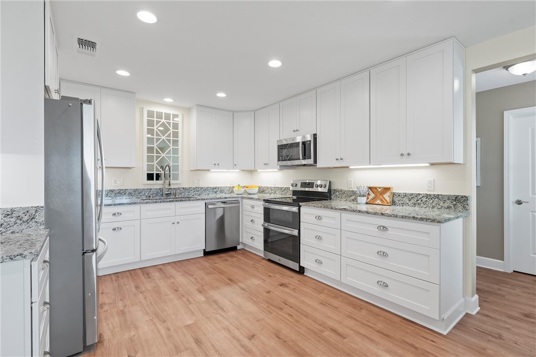 1748 Downsville Road Robinson, TX 76706 - Photo 18 of 65 a kitchen with granite countertop white cabinets and stainless steel appliances