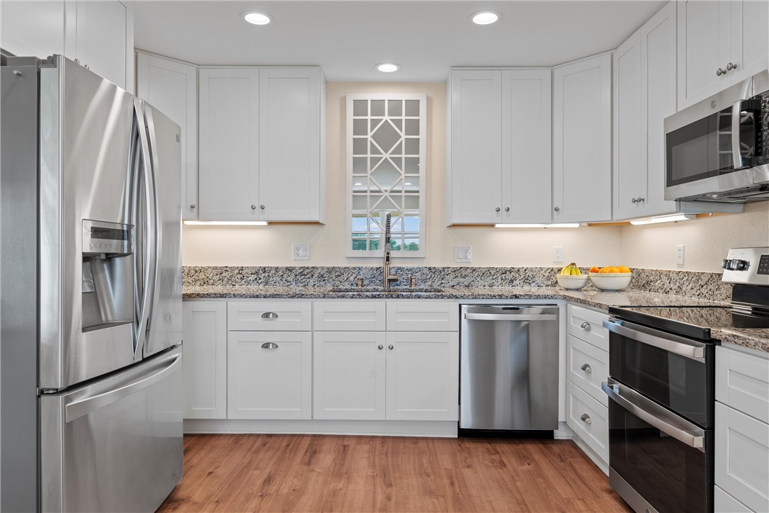 1748 Downsville Road Robinson, TX 76706 - Photo 19 of 65 a kitchen with stainless steel appliances granite countertop a refrigerator sink and stove