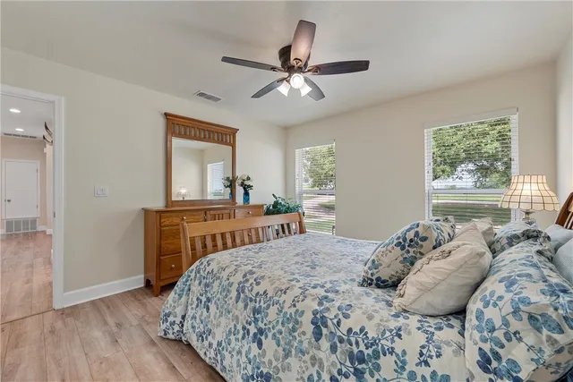 a bedroom with a bed and a ceiling fan