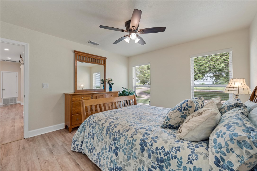 1748 Downsville Road Robinson, TX 76706 - Photo 26 of 65 a bedroom with a bed and a chandelier