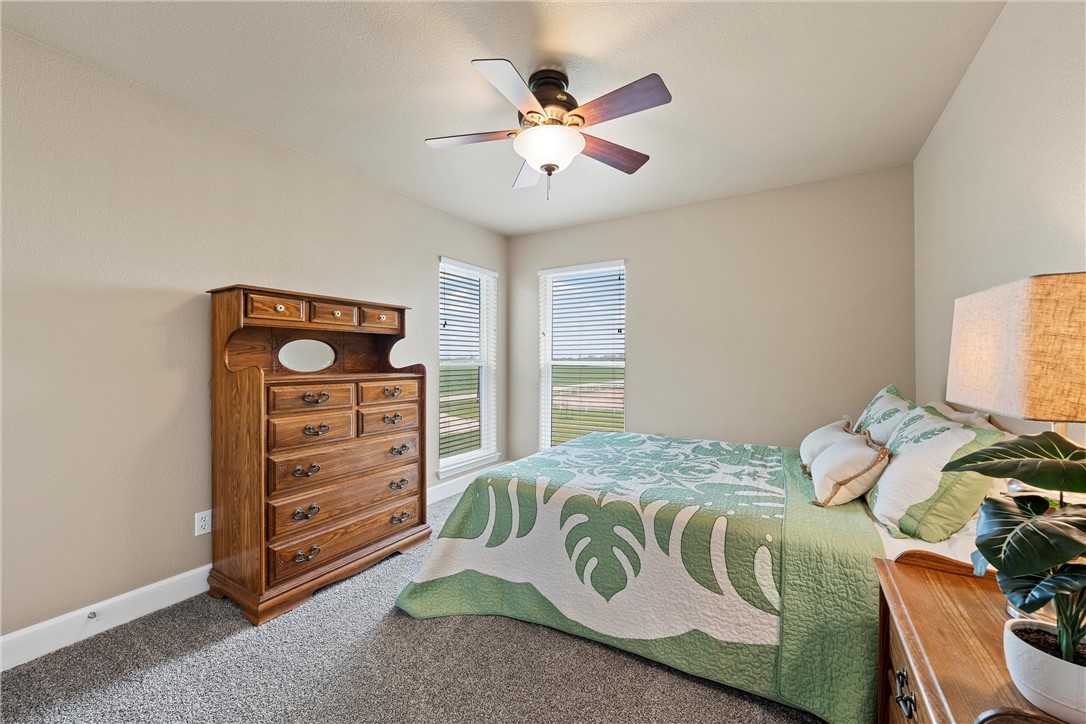 1748 Downsville Road Robinson, TX 76706 - Photo 31 of 65 a bedroom with a bed and a ceiling fan