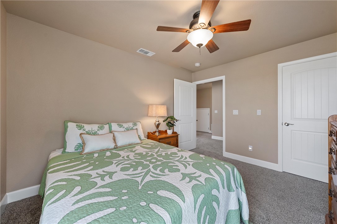 1748 Downsville Road Robinson, TX 76706 - Photo 32 of 65 a bedroom with a large bed and a chandelier