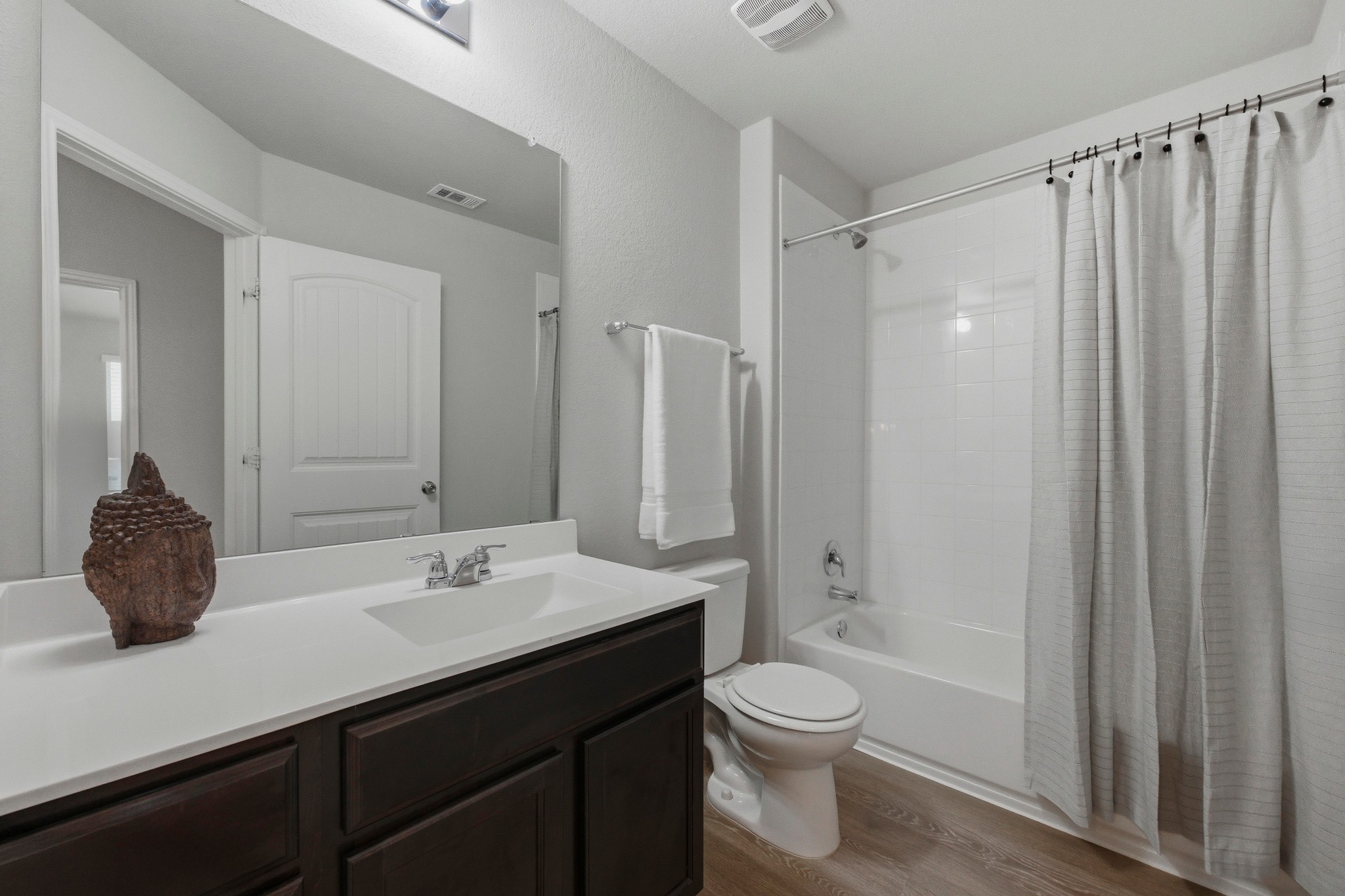 516 East Slaughter Lane, Unit 2402 Austin, TX 78744 - Photo 17 of 27 a bathroom with a double vanity sink toilet and shower