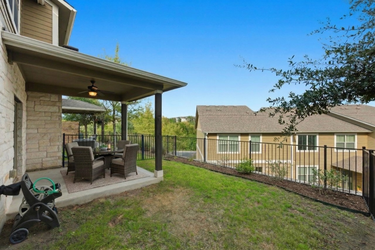 516 East Slaughter Lane, Unit 2402 Austin, TX 78744 - Photo 22 of 27 a view of a house with backyard sitting area and garden