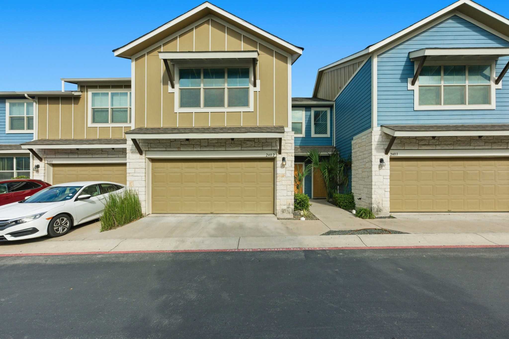 516 East Slaughter Lane, Unit 2402 Austin, TX 78744 - Photo 27 of 27 a front view of a house with parking area
