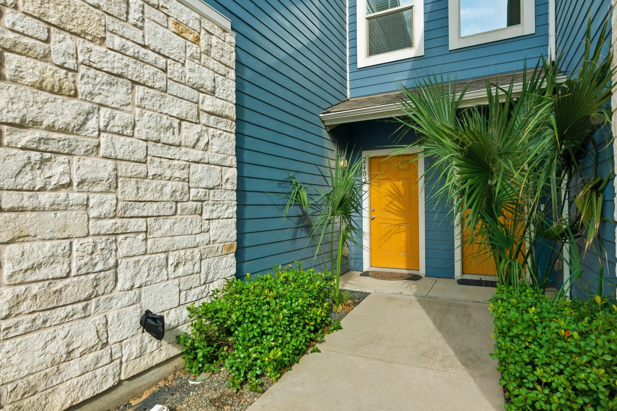 516 East Slaughter Lane, Unit 2402 Austin, TX 78744 - Photo 3 of 27 a front view of a house with a yard