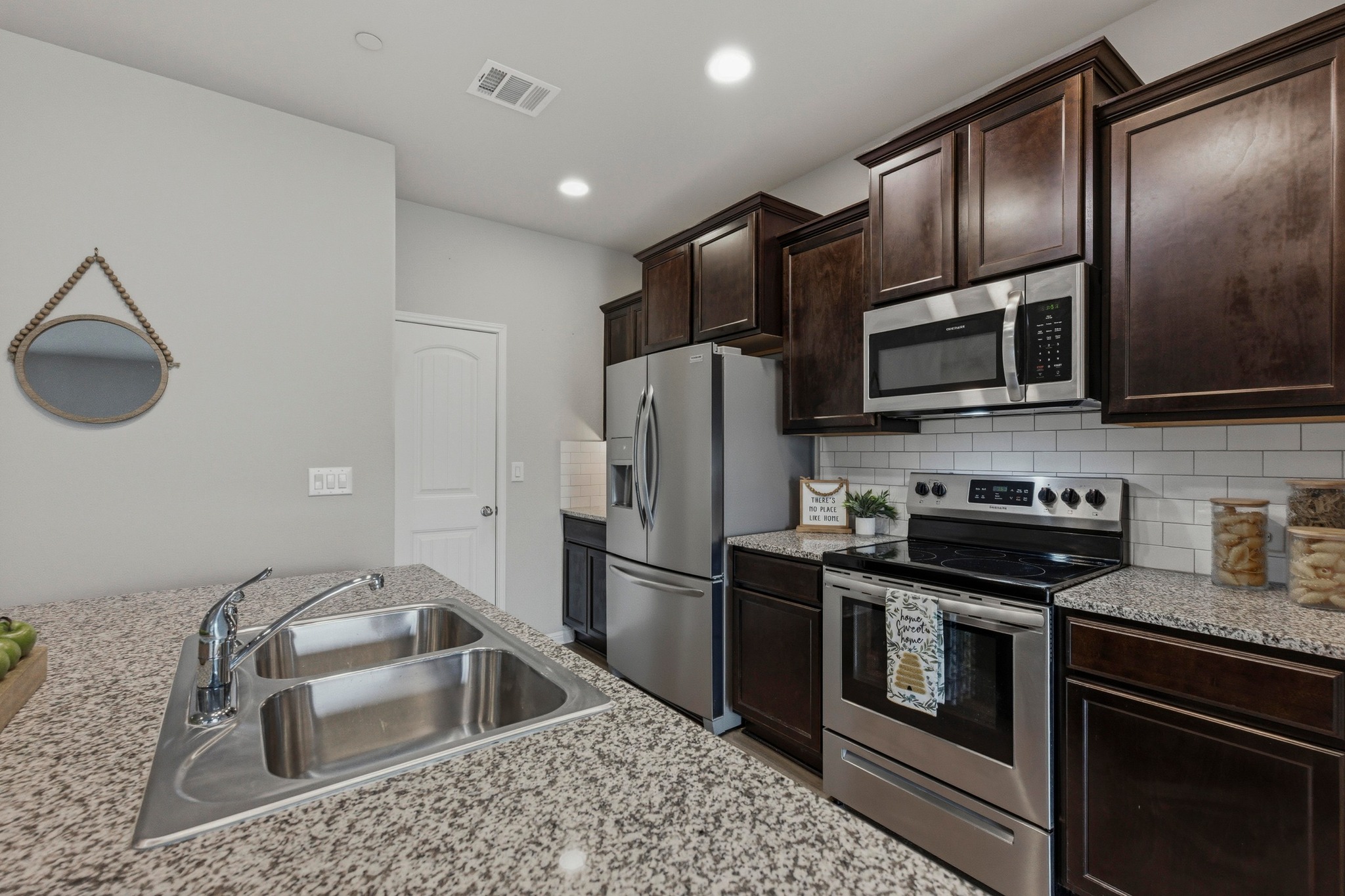 516 East Slaughter Lane, Unit 2402 Austin, TX 78744 - Photo 7 of 27 a kitchen with a sink stove and refrigerator