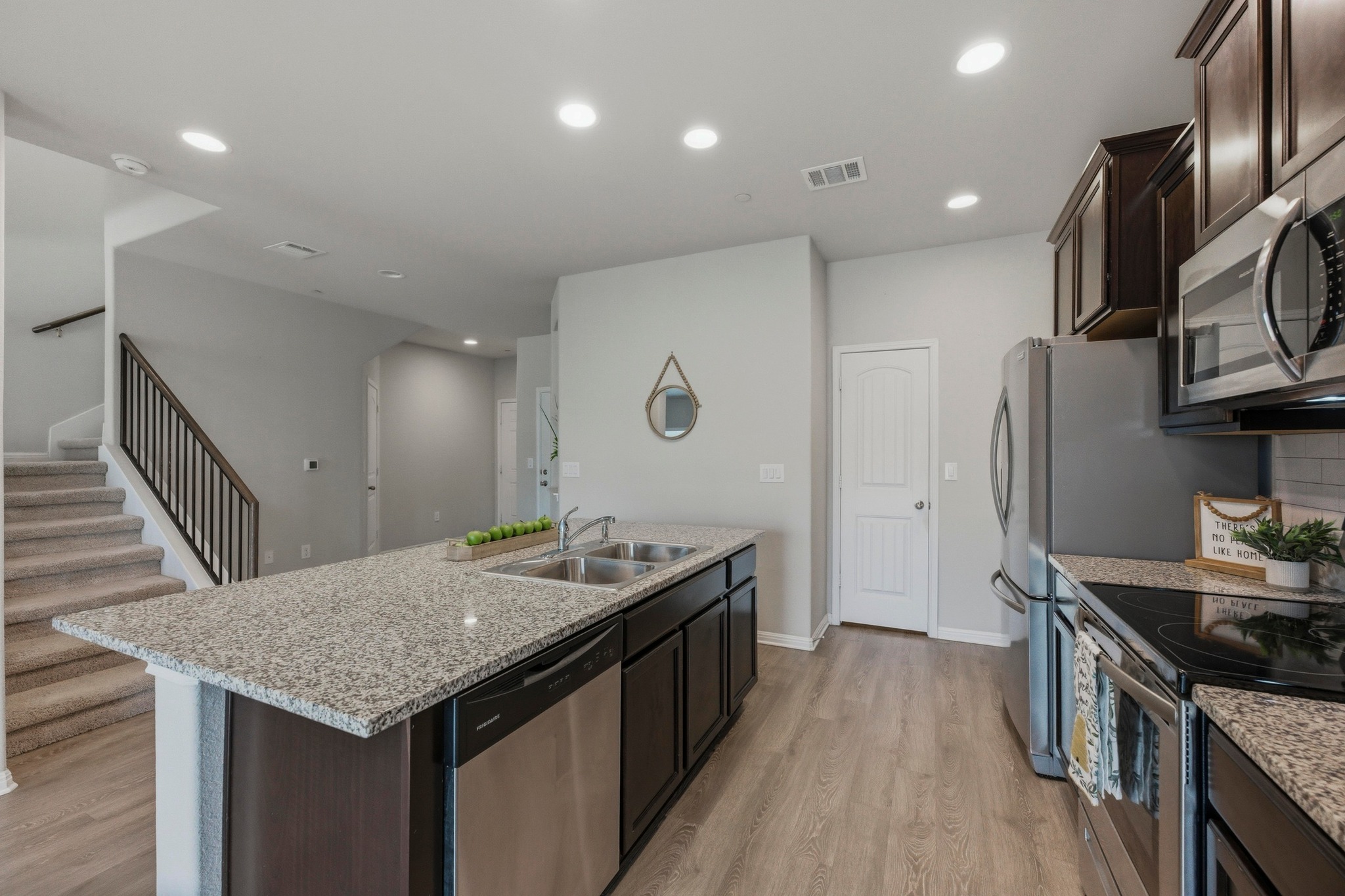 516 East Slaughter Lane, Unit 2402 Austin, TX 78744 - Photo 8 of 27 a kitchen with granite countertop a stove a sink dishwasher and a refrigerator