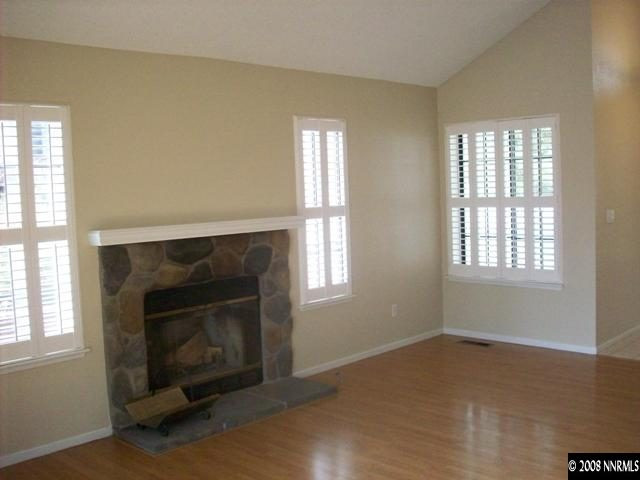 5898 Walnut Creek Road Reno, NV 89523 - Photo 3 of 8 an empty room with windows and fireplace