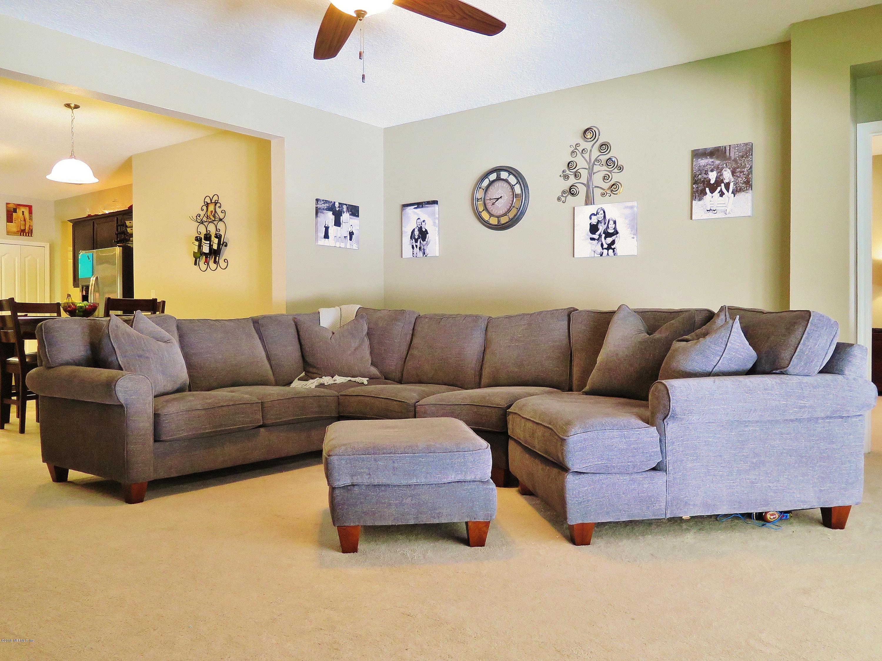 16504 Tisons Bluff Road Jacksonville, FL 32218 - Photo 11 of 34 a living room with furniture and a couch