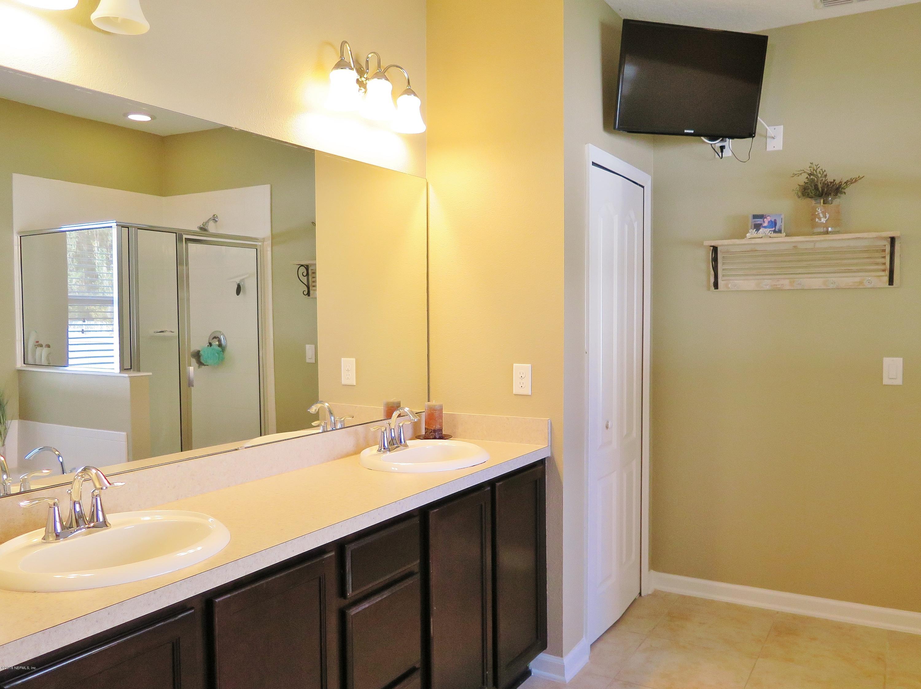 16504 Tisons Bluff Road Jacksonville, FL 32218 - Photo 14 of 34 a bathroom with a sink and a mirror