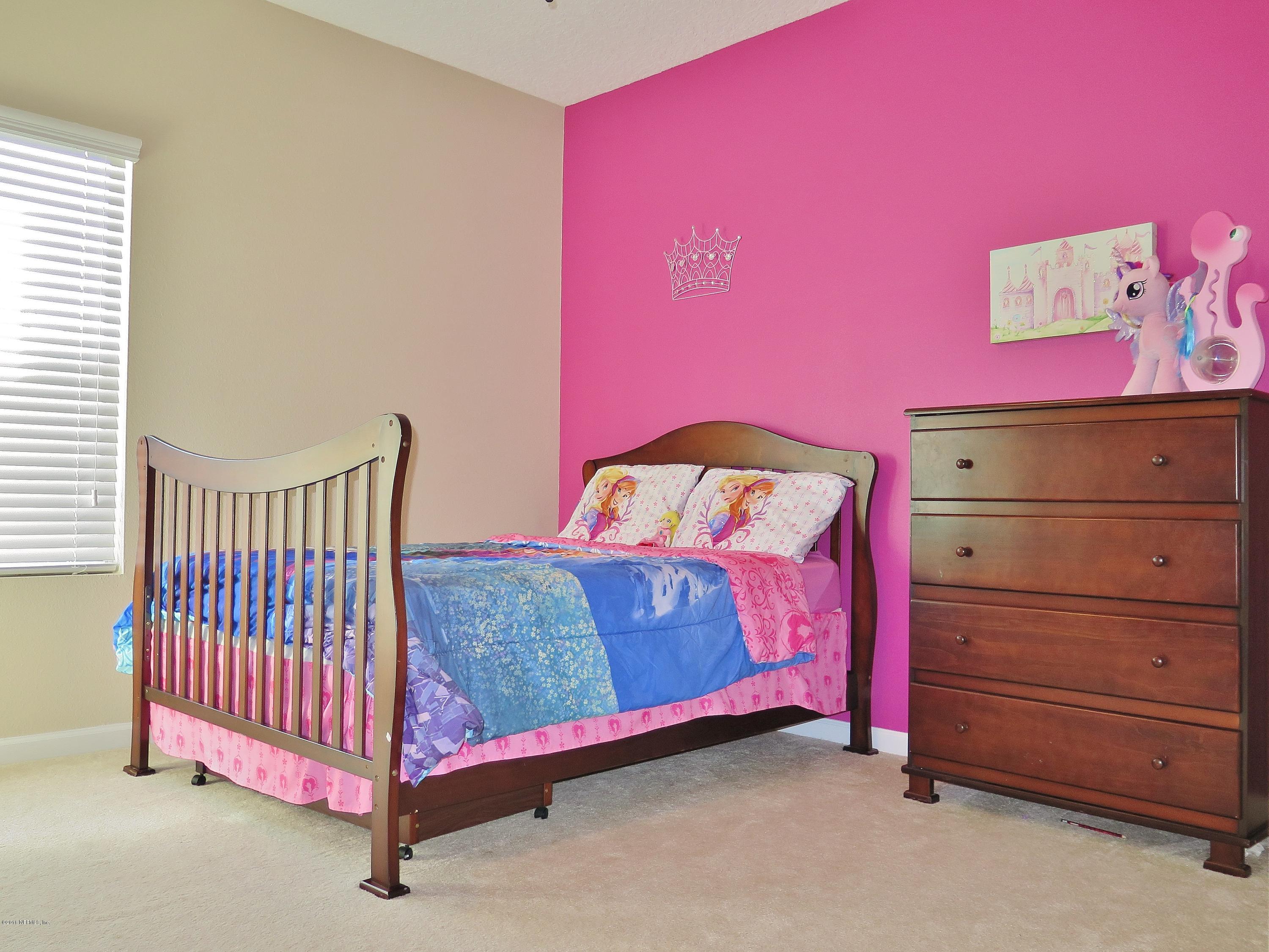 16504 Tisons Bluff Road Jacksonville, FL 32218 - Photo 16 of 34 a bed room with a bed and a chair