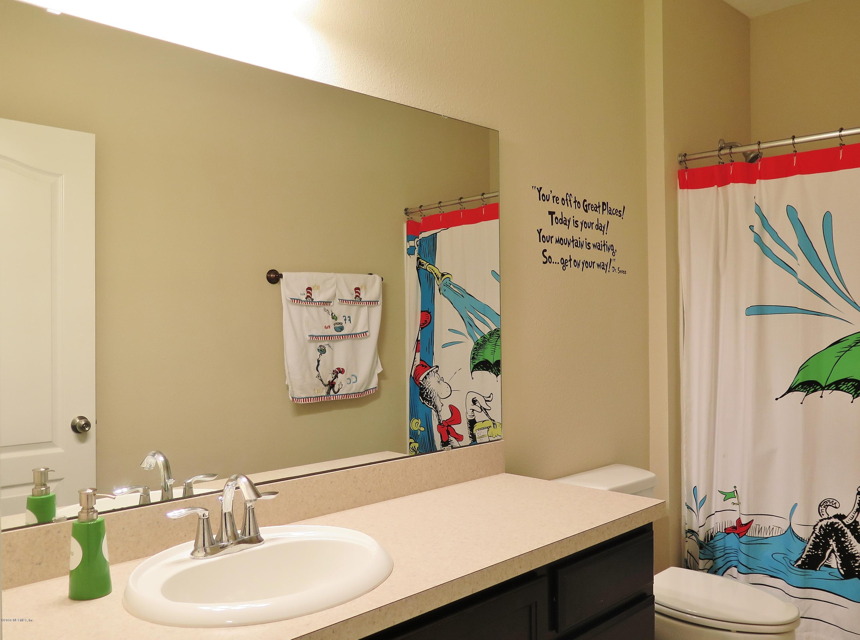 16504 Tisons Bluff Road Jacksonville, FL 32218 - Photo 17 of 34 a bathroom with a sink vanity mirror and toilet