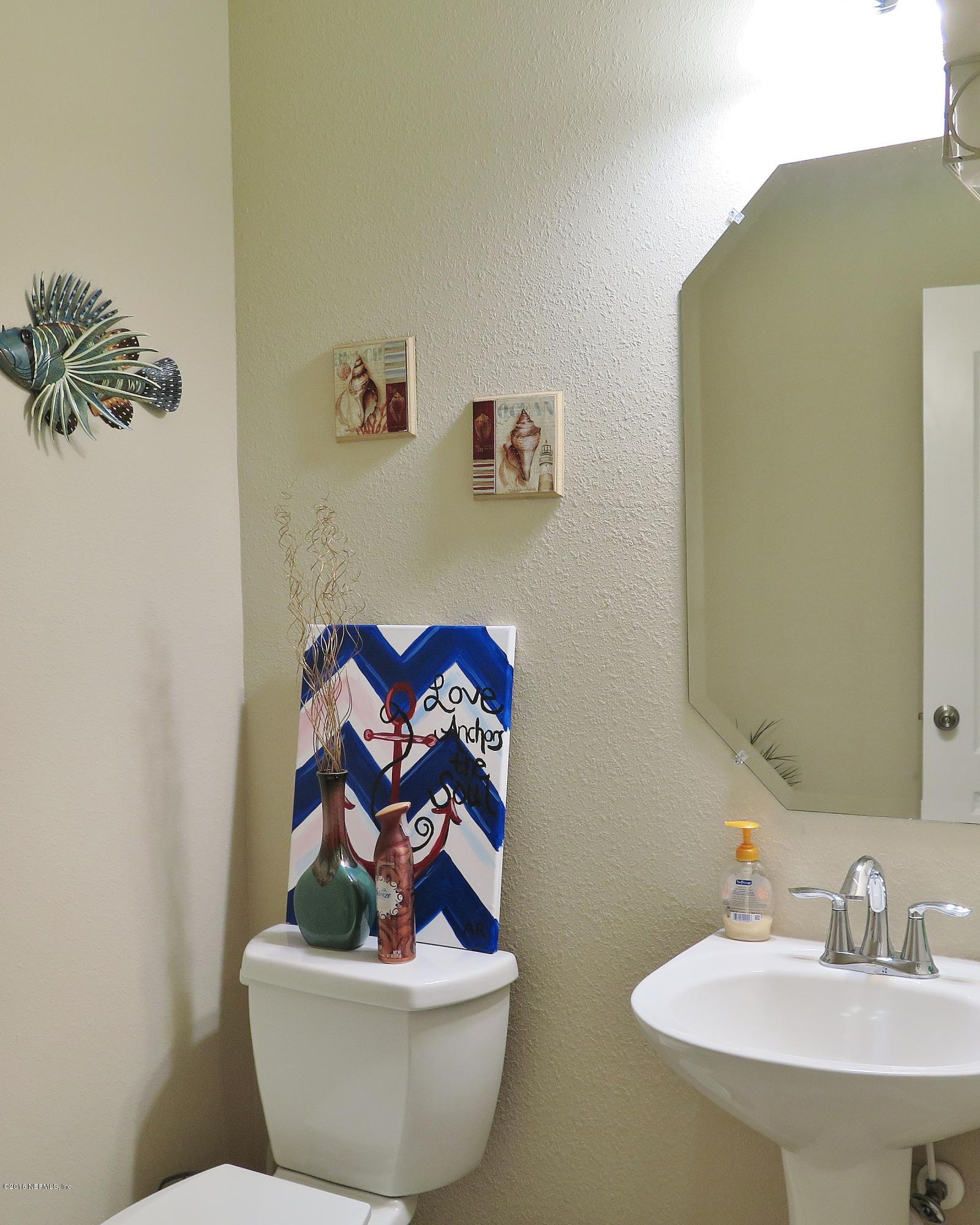 16504 Tisons Bluff Road Jacksonville, FL 32218 - Photo 21 of 34 a bathroom with a sink and a mirror