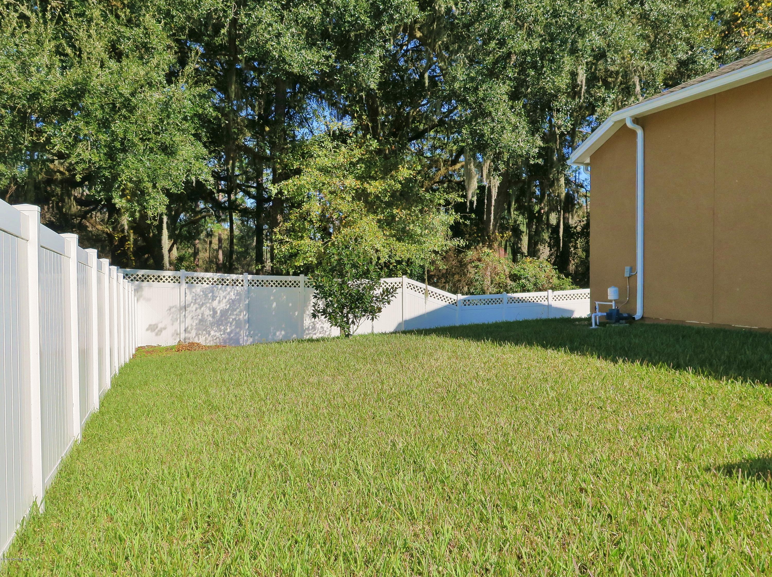 16504 Tisons Bluff Road Jacksonville, FL 32218 - Photo 22 of 34 a view of a backyard with large trees