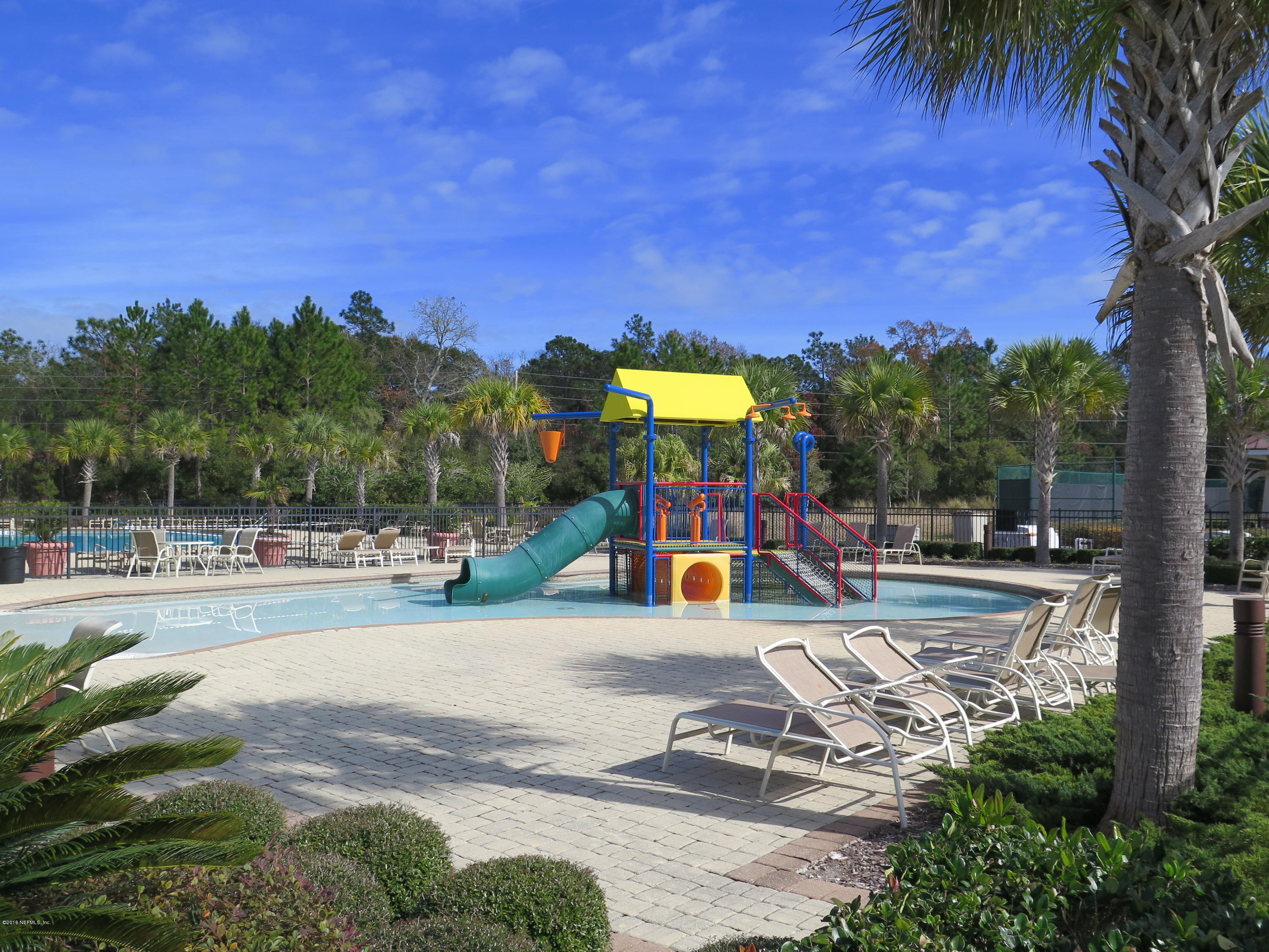 16504 Tisons Bluff Road Jacksonville, FL 32218 - Photo 28 of 34 a view of a swimming pool with a patio and a yard
