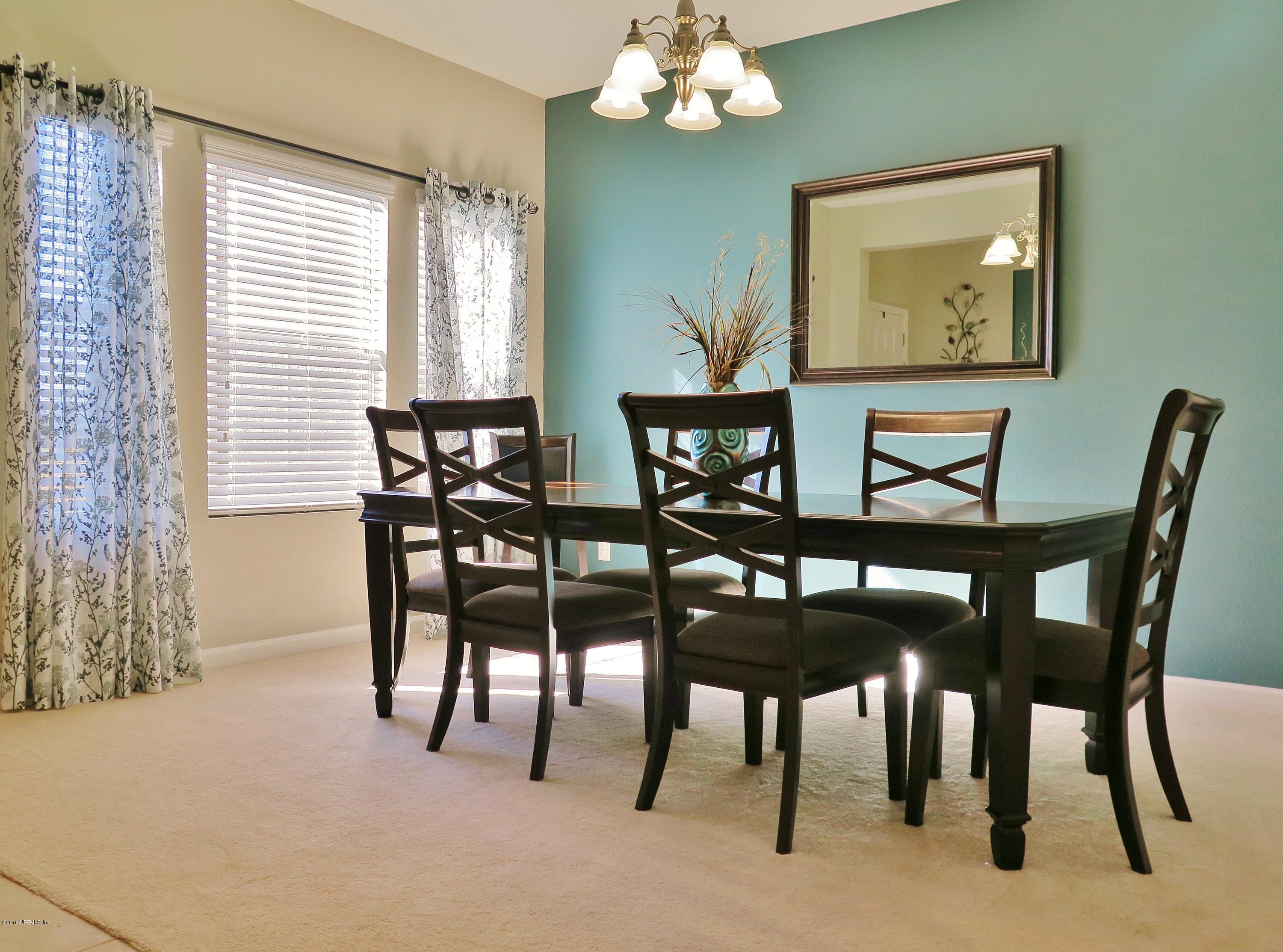 16504 Tisons Bluff Road Jacksonville, FL 32218 - Photo 5 of 34 a view of a dining room with furniture and chandelier