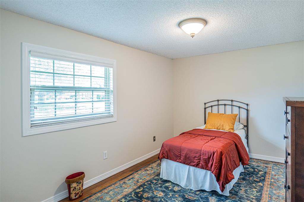 741 Brookside Road Maitland, FL 32751 - Photo 22 of 43 a bed sitting in a bedroom next to a window