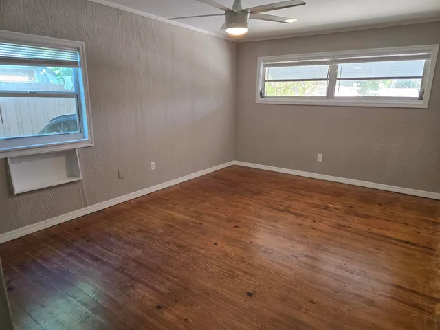 a bathroom with a granite countertop toilet sink and mirror