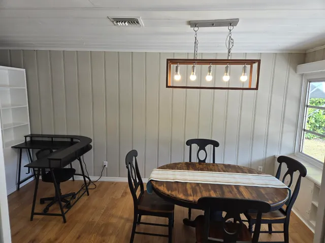 a bedroom with a bed a desk and chair