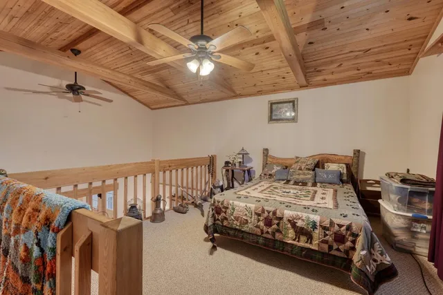 a bedroom with bed and wooden floor