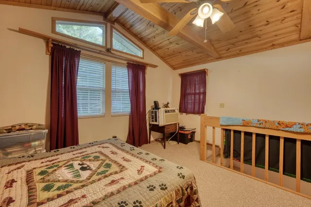 a bed sitting in a bedroom next to a window