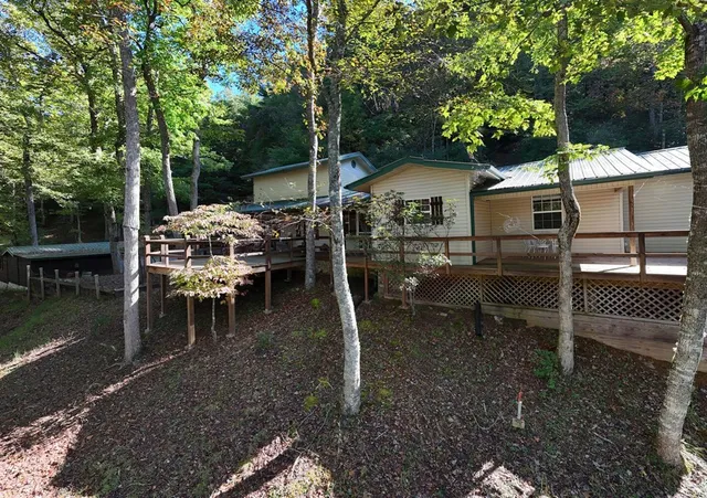a view of house with a yard and sitting area