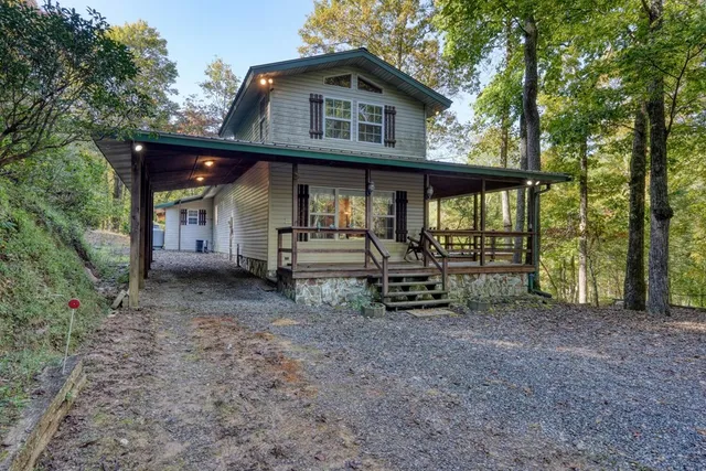 a view of a house with backyard and sitting area