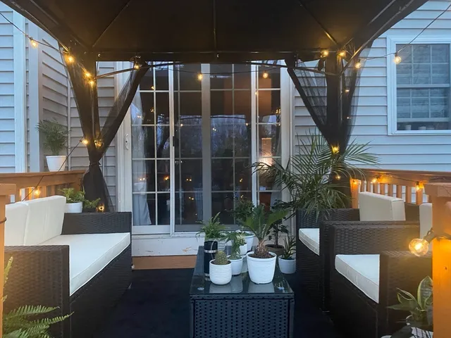a view of balcony with chairs and potted plants