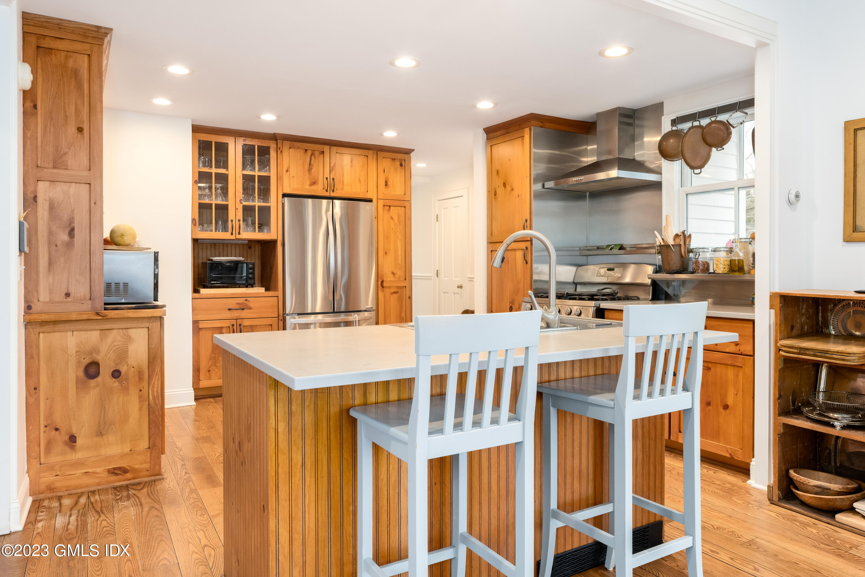 93 Riverside Avenue Riverside, CT 06878 - Photo 12 of 19 a kitchen with stainless steel appliances kitchen island granite countertop a refrigerator a stove a oven a sink with island and chairs