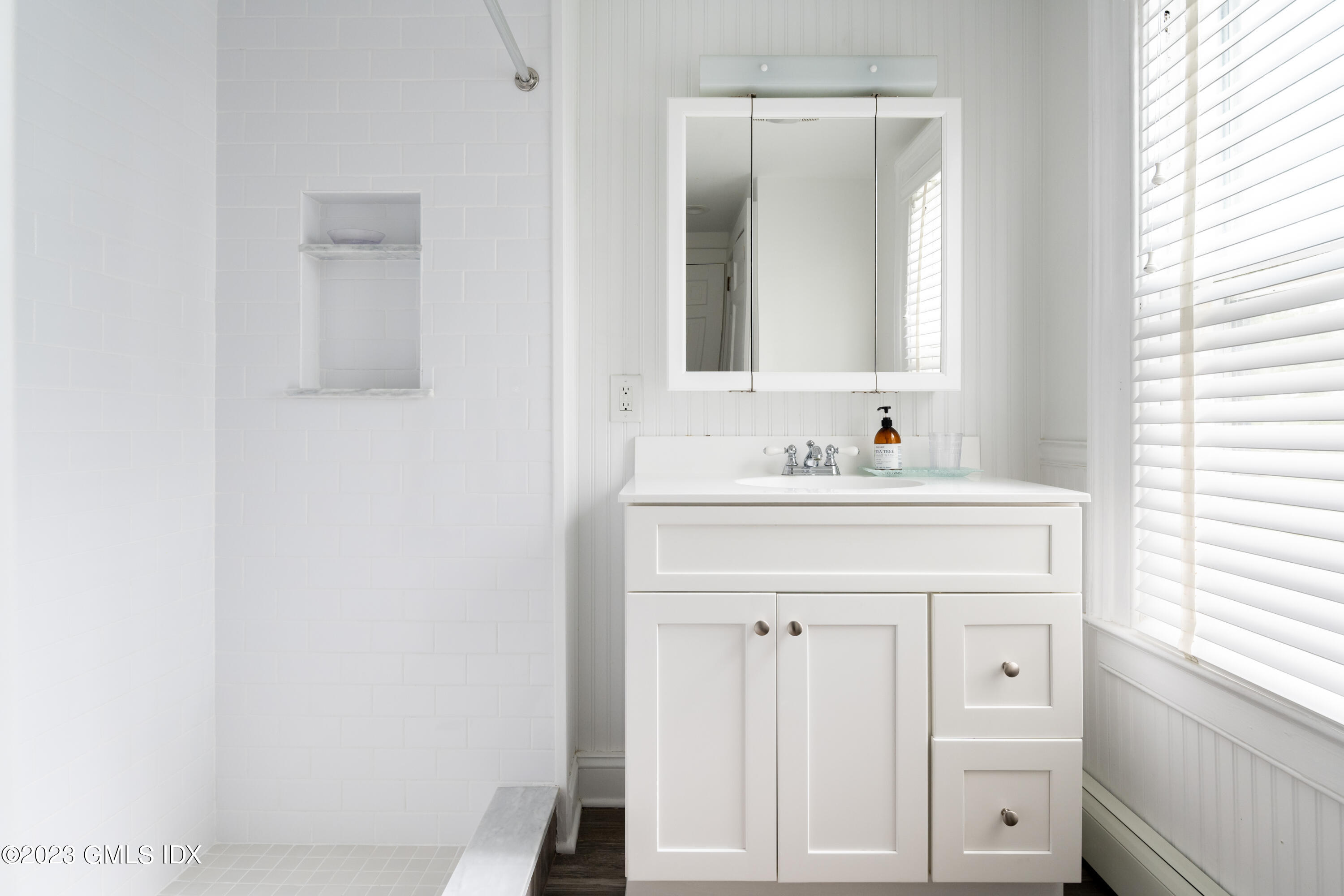 93 Riverside Avenue Riverside, CT 06878 - Photo 17 of 19 a bathroom with a sink vanity and a mirror