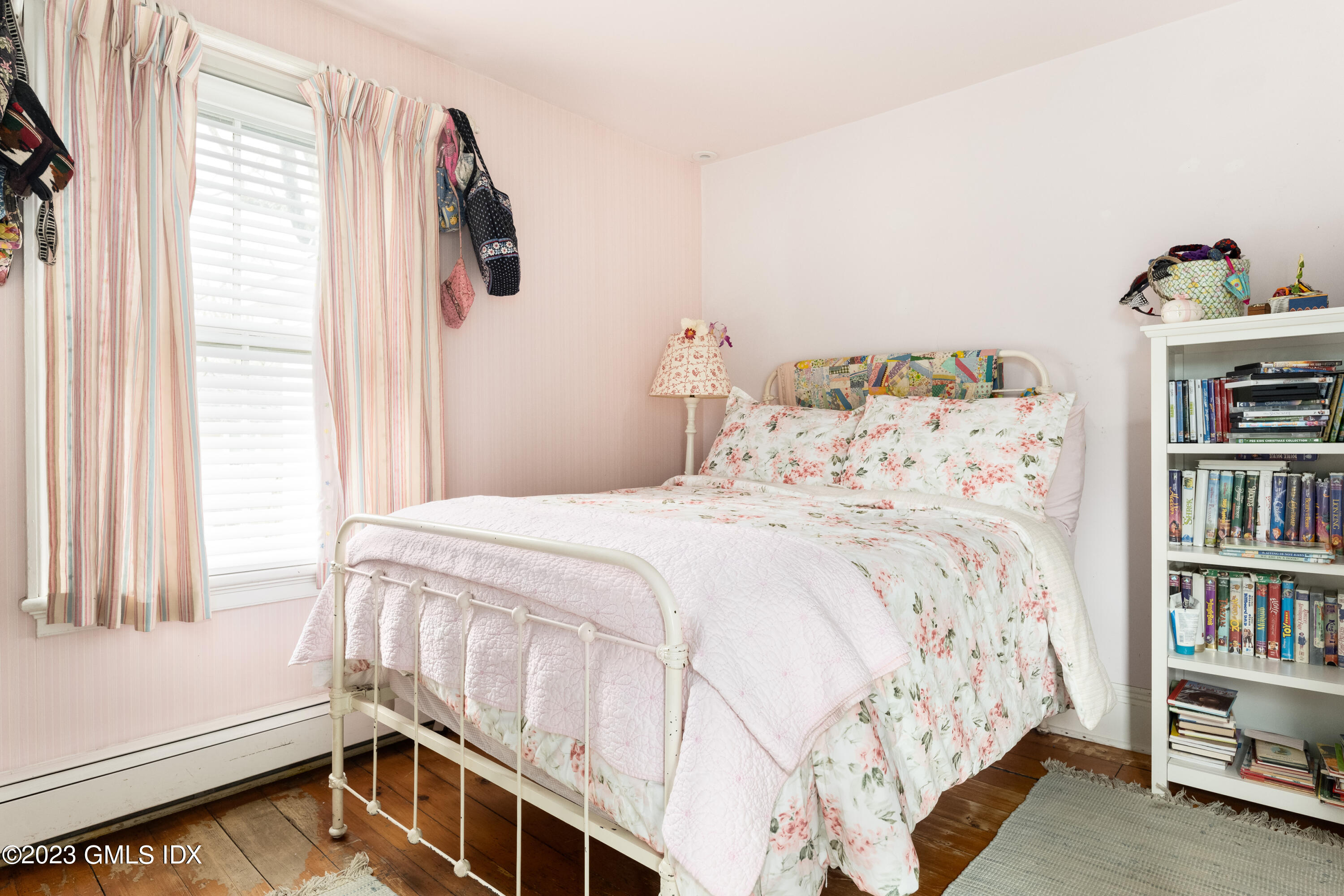 93 Riverside Avenue Riverside, CT 06878 - Photo 18 of 19 a bedroom with a bed and a book shelf