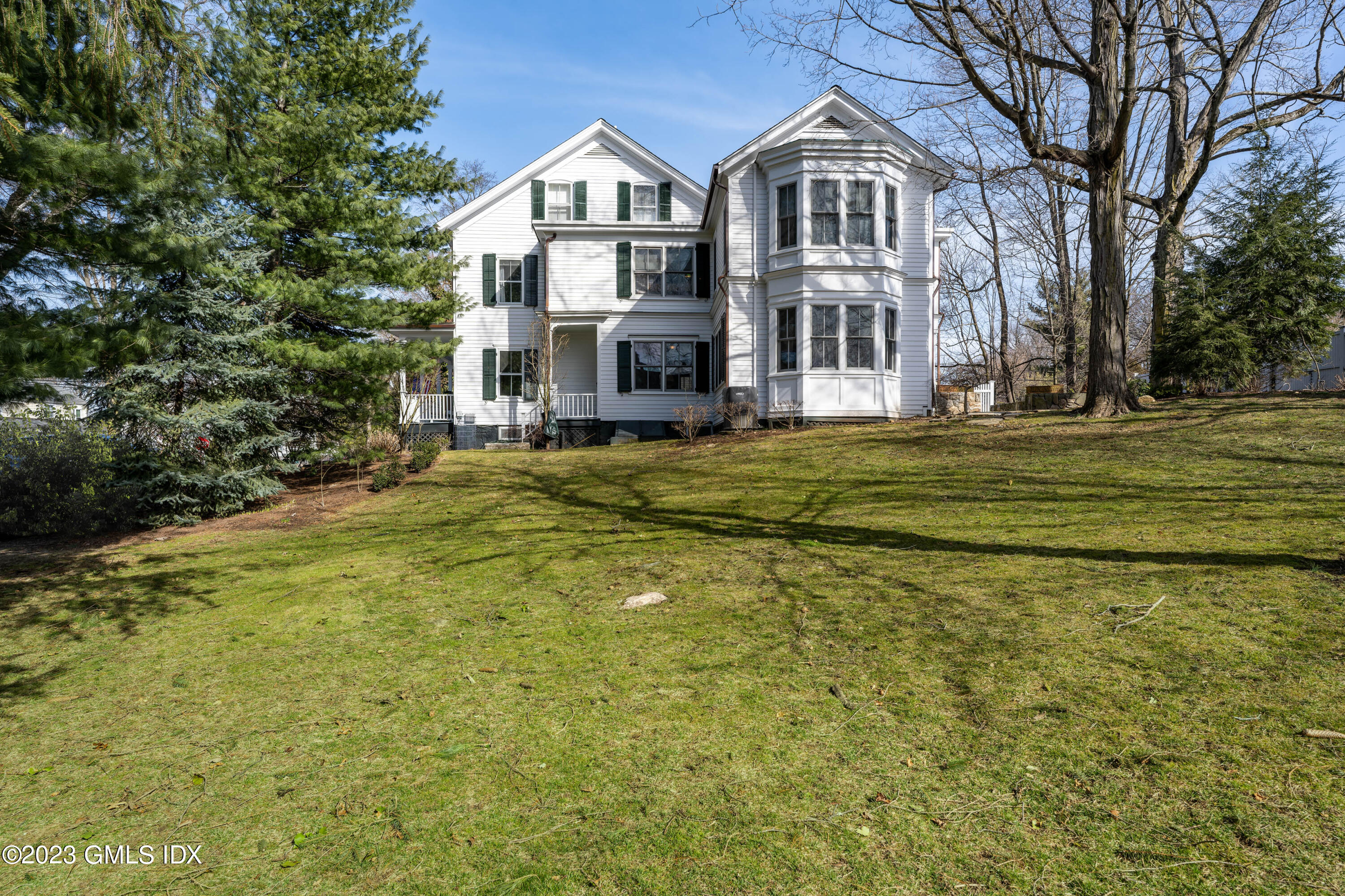 93 Riverside Avenue Riverside, CT 06878 - Photo 3 of 19 a front view of a house with a garden