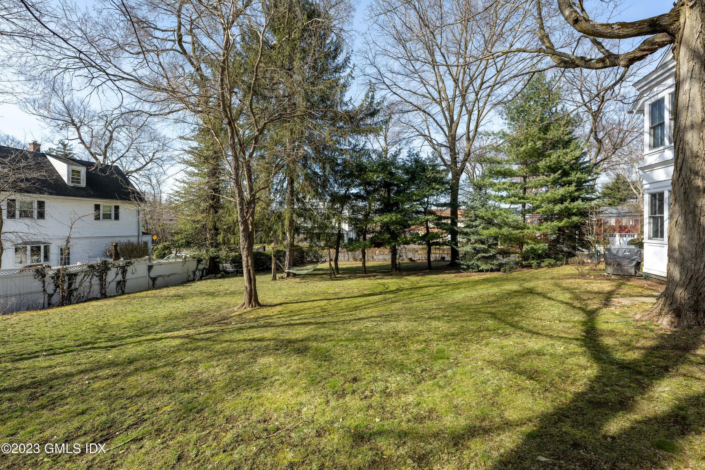 93 Riverside Avenue Riverside, CT 06878 - Photo 5 of 19 a swimming pool with outdoor seating and yard
