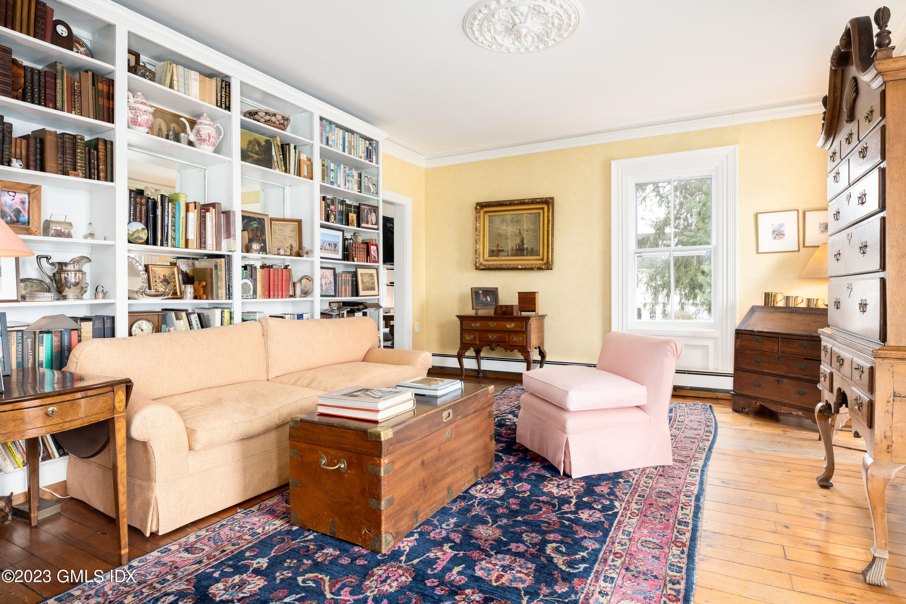 93 Riverside Avenue Riverside, CT 06878 - Photo 7 of 19 a living room with furniture and a bookshelf